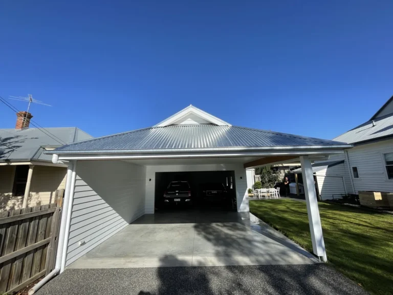 Carport attached to traditional home on sunny day.